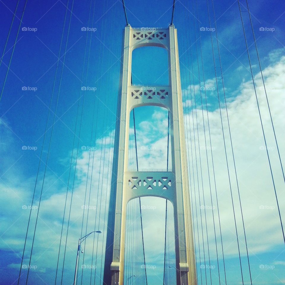 Bridge the gap. Driving from the lower peninsula over the Mackinac Bridge into the upper peninsula of Michigan.