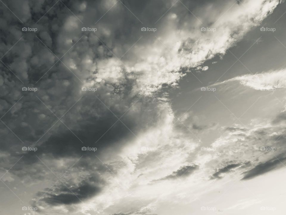 A black and white photo of a cloudy sky. 
