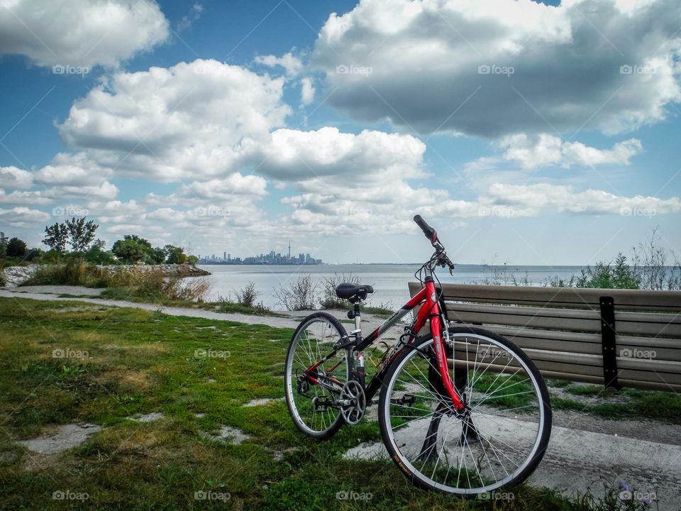 Beautiful red bicycle by the lake