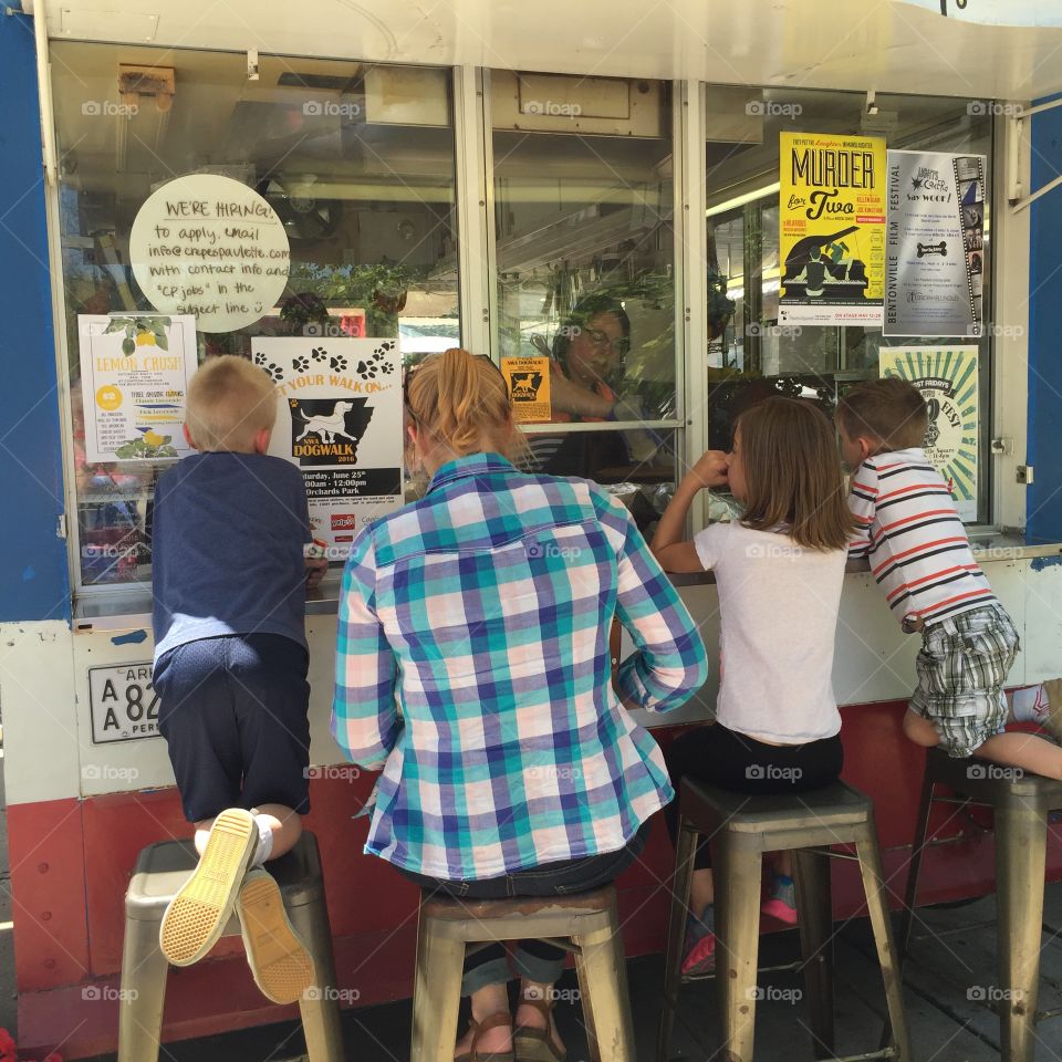 Mother and children ordering lunch at a food truck