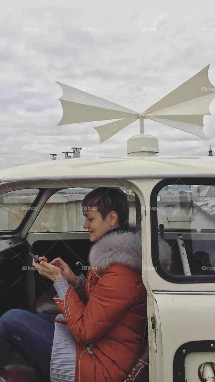 Girl with smartphone in the car 