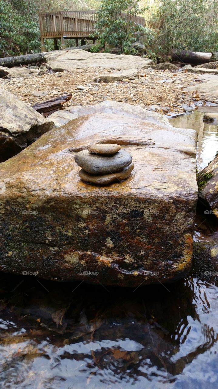 stacked rocks on water. found near a waterfall while hiking