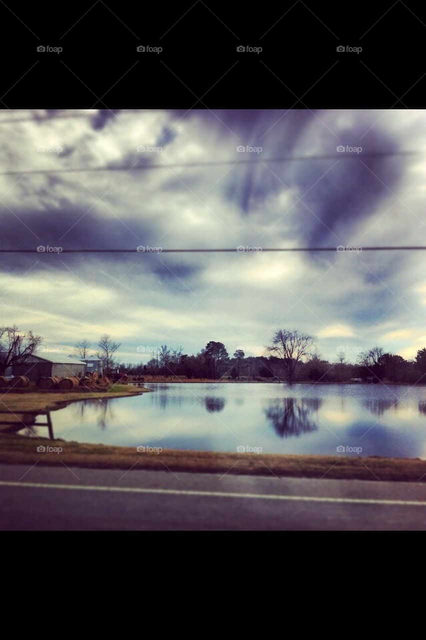 Clouds above a farm pond