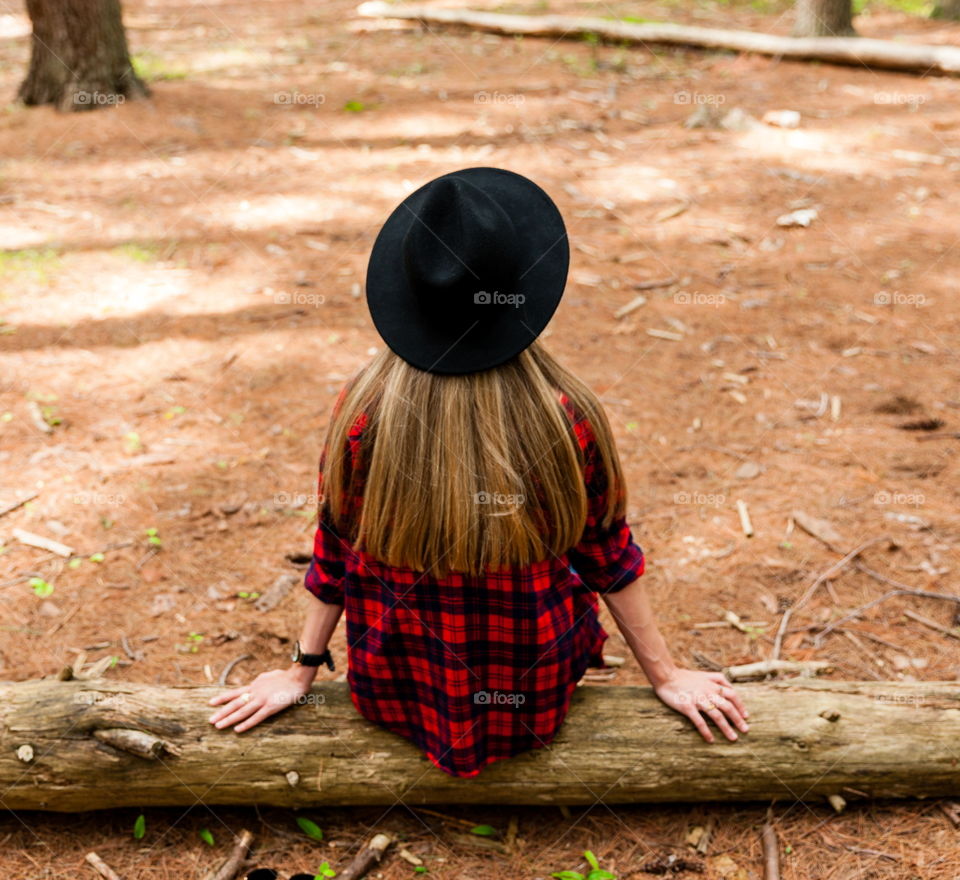 Girl sitting on log