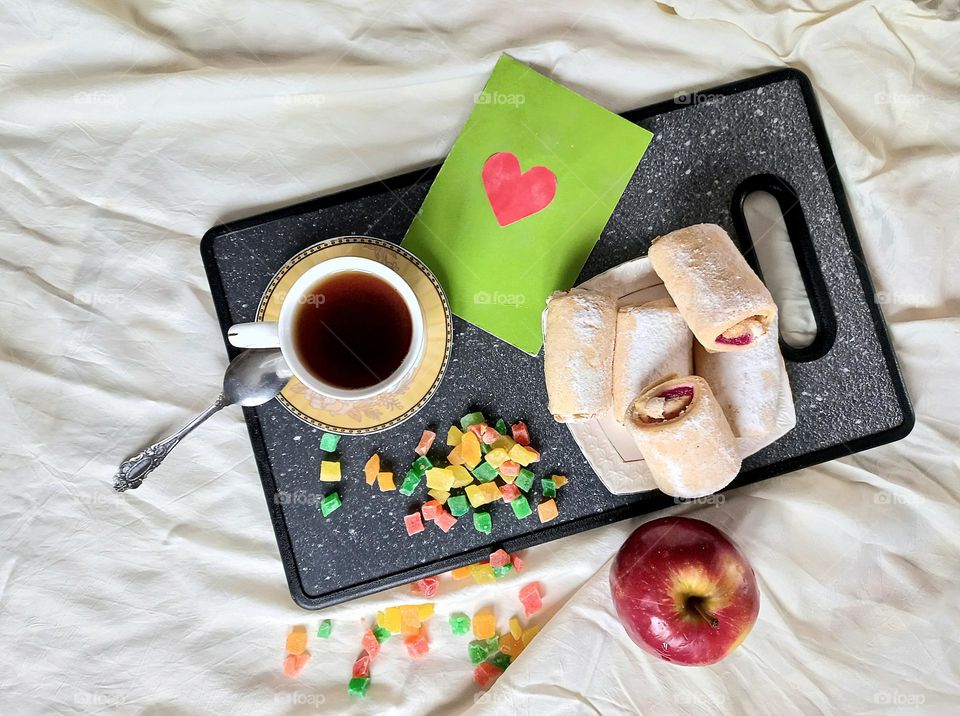 time to drink coffee! a cup of aromatic coffee, strudel with cherry jam, candied fruits and an apple!