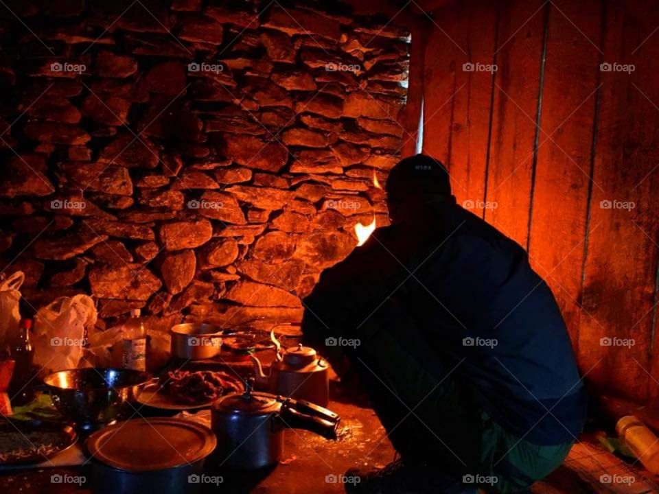 Cooking dinner at Italian Base Camp. The warm we felt being in that traditional kitchen was priceless. Taken on the Dhaulagiri Circuit Trek in Nepal.