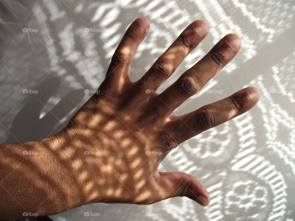 a hand in light and shadows