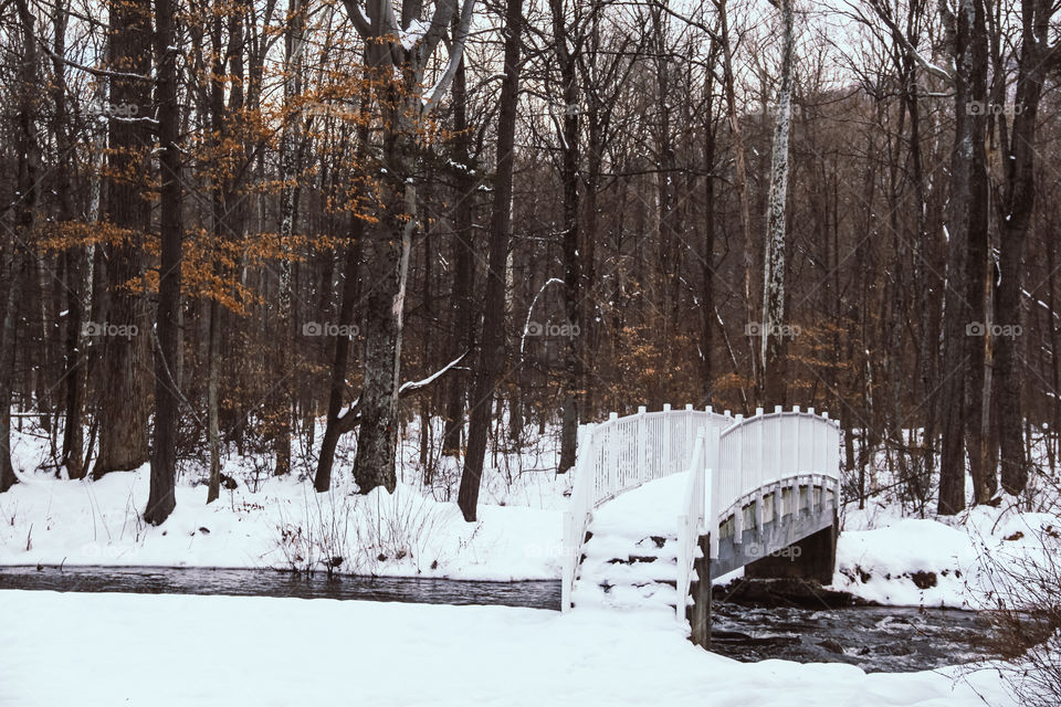 A snow covered bridge in the winter.