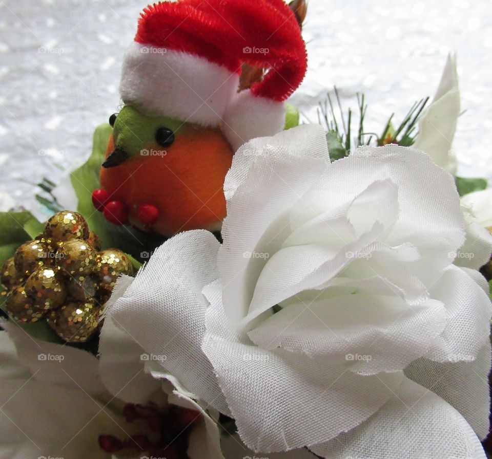 Christmas silk flower arrangement with a robin wearing a Santa hat