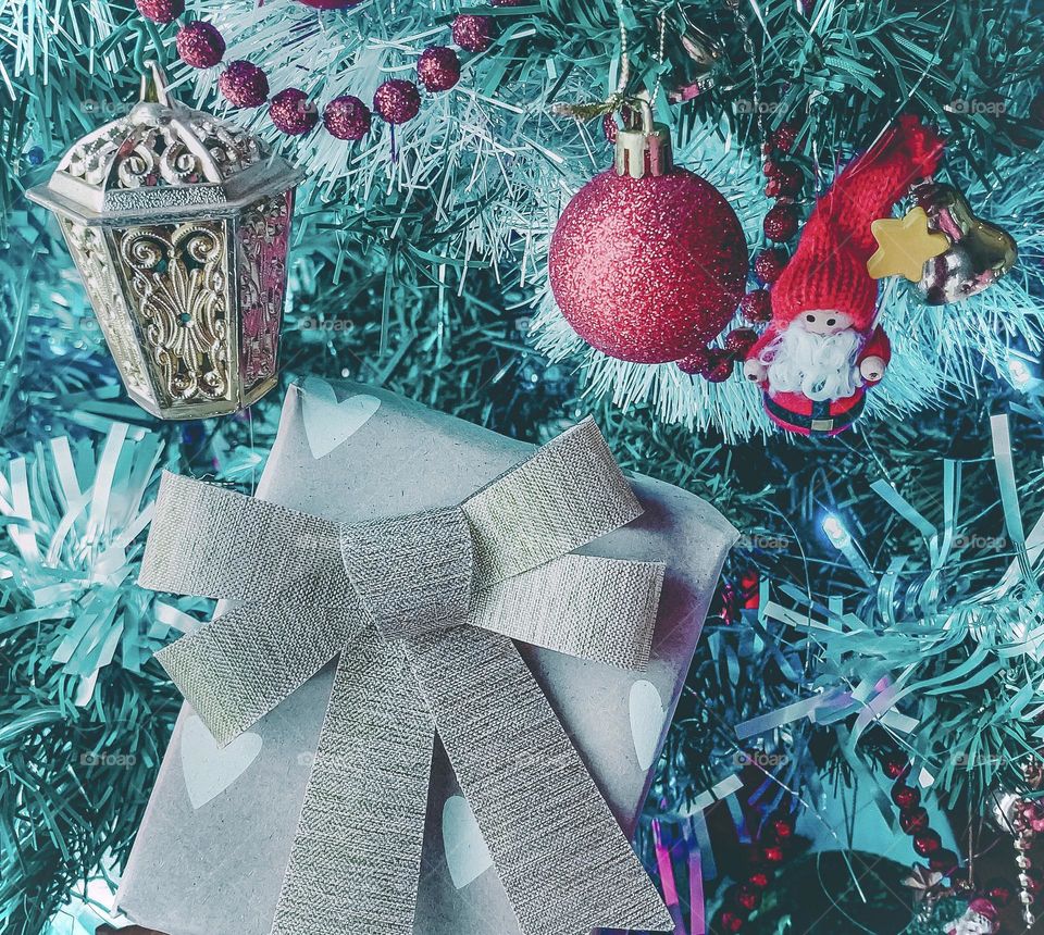 A present amid the decorations on a Christmas tree