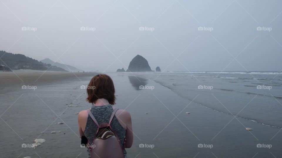 Girl With Haystack Rock Visible in Background