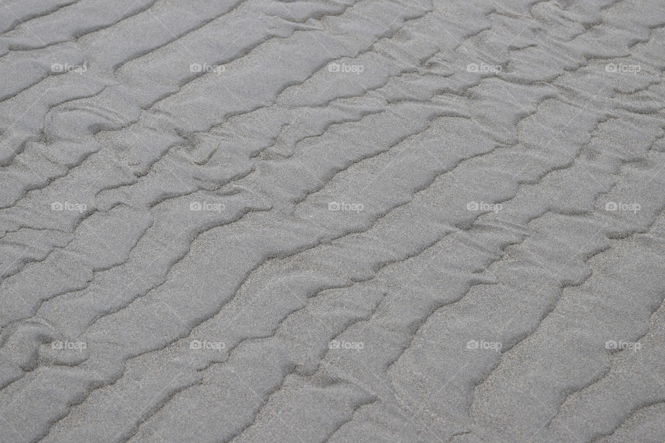 Beach sands naturally lined and formed by ocean waves