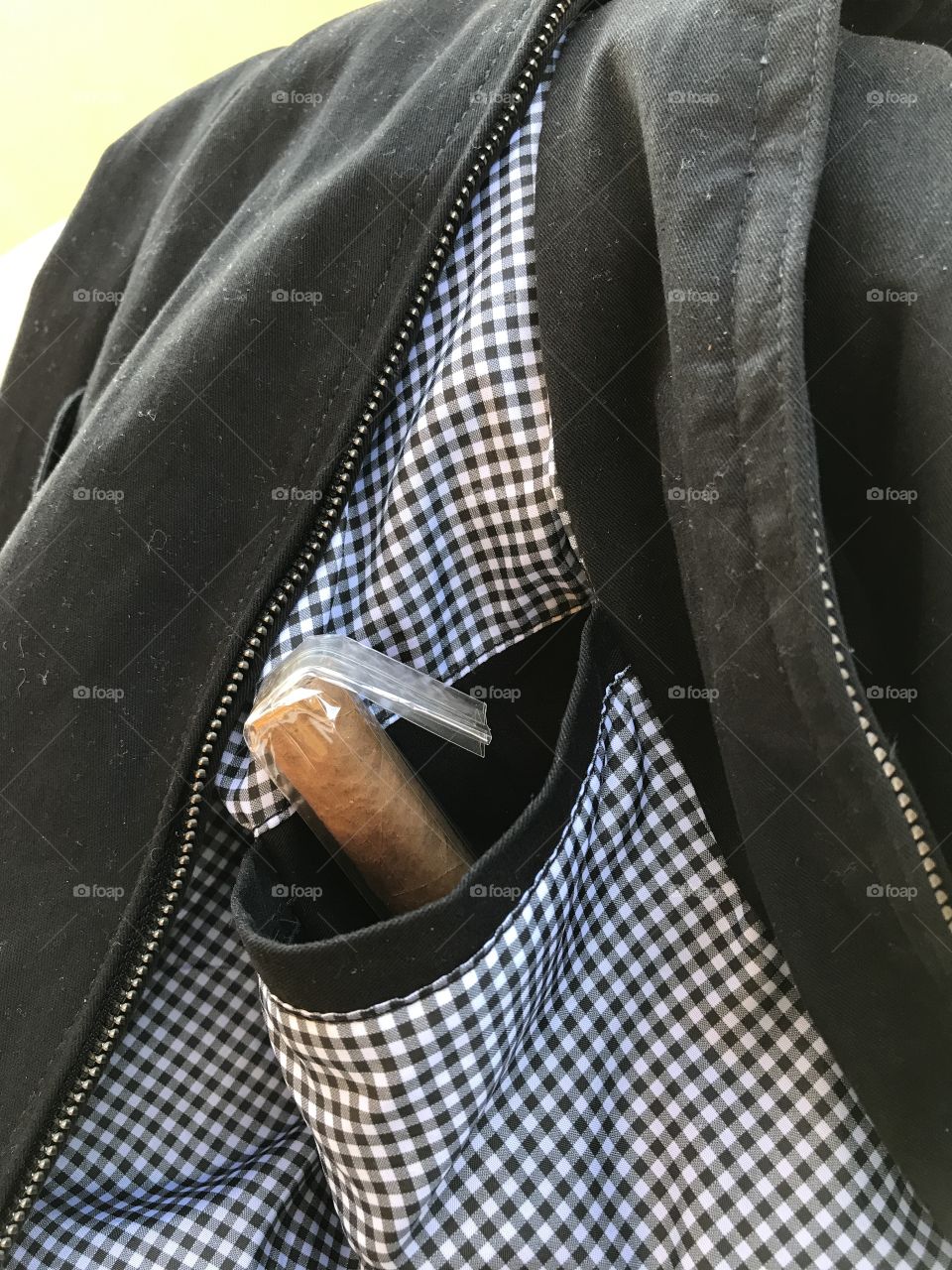 Cigar in jacket pocket.