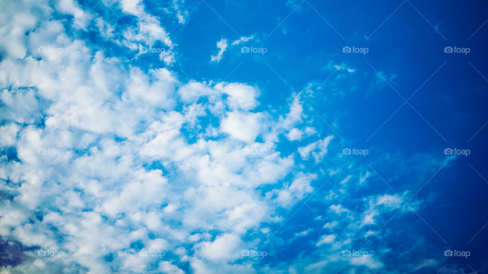 Large clouds float across the sunset sky like sails.