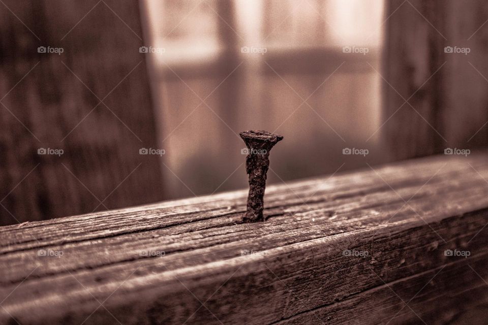 rusty nail in an old board