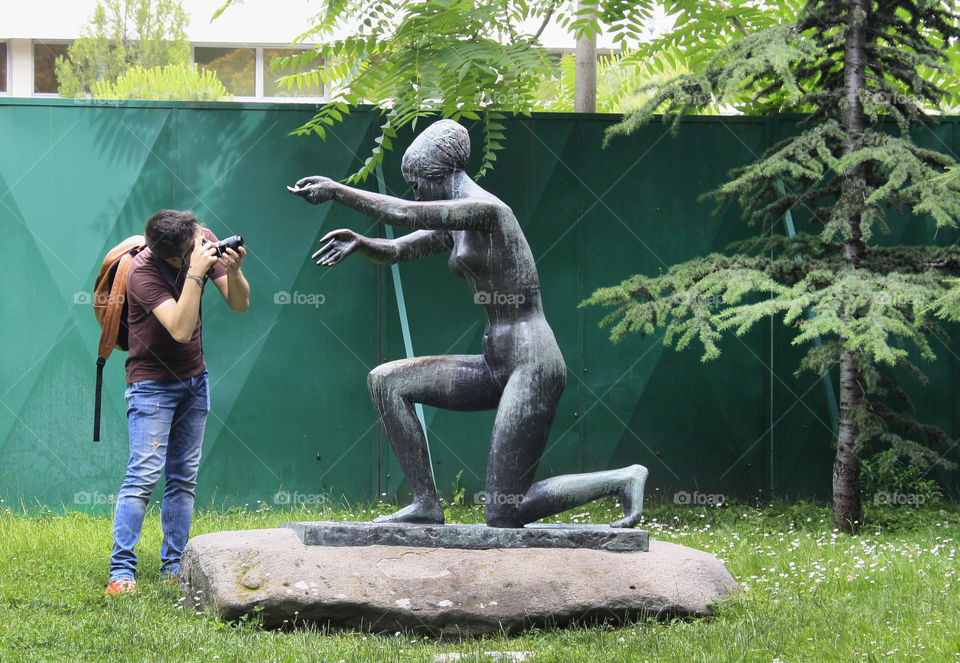 Photographer shooting a statue of a woman