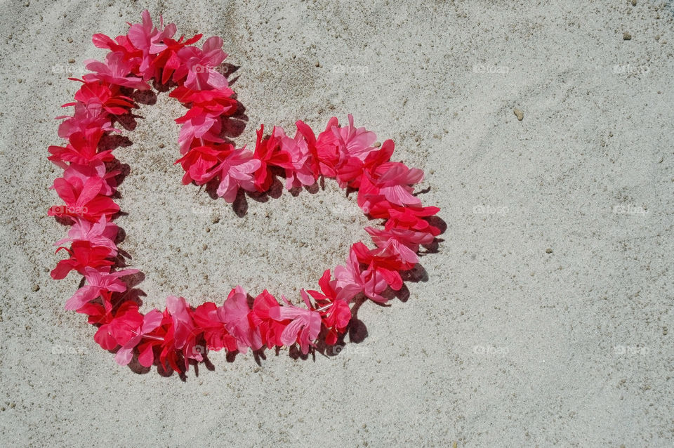 Leis shaped like a heart on the beach. Room for your copy. 