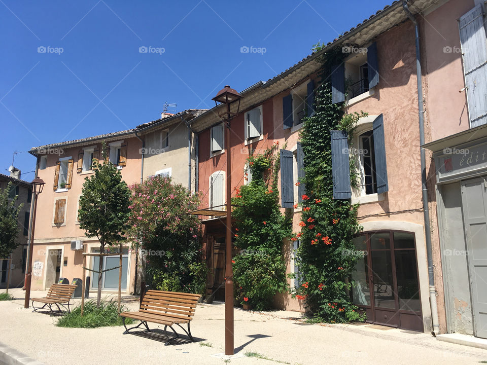 Street with colored houses and a bench