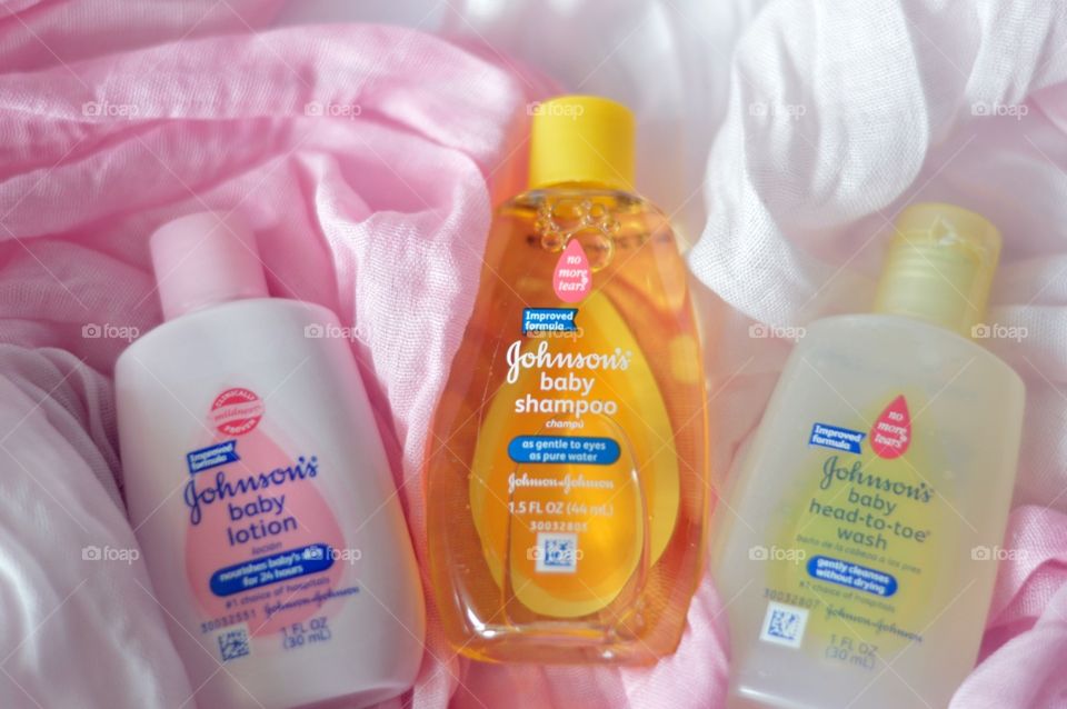Johnson & Johnson’s baby products on a soft pink background flat lay 