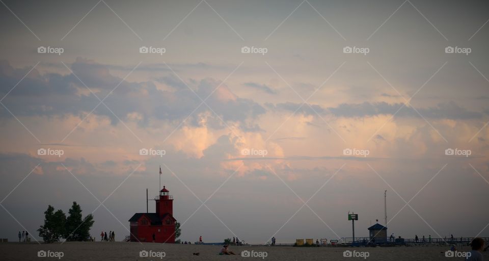 Summer sunset at the beach with lighthouse
