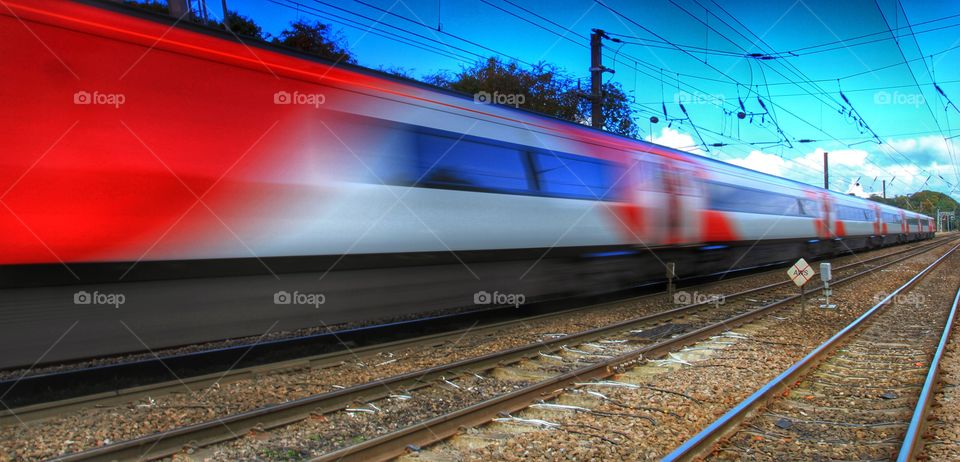 Speeding Train. A high speed passenger express train flies past in a blur.