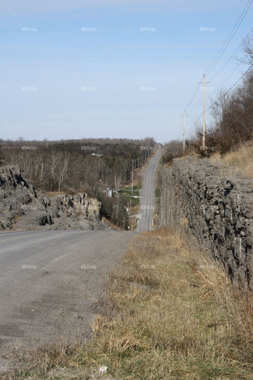 A road through a deep rock through a valley and over a river in the small village of Kingsford, Ontario
