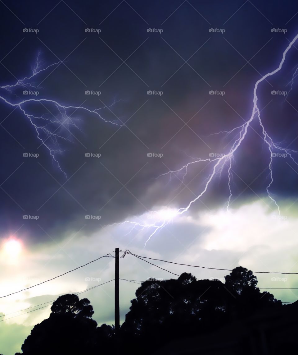 Dangerous lightning strikes light up the dark sky.