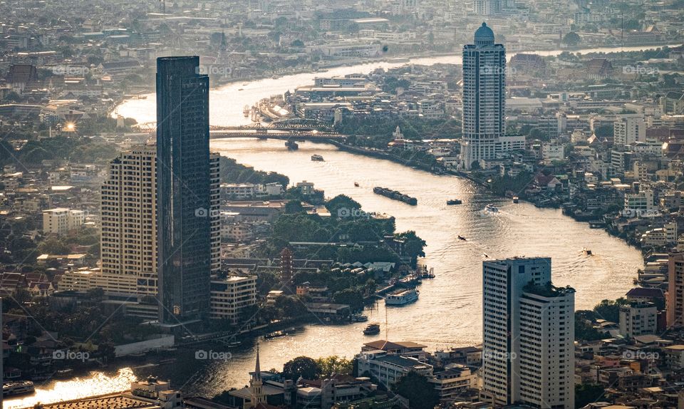 Beautiful river leading line pass through skyscraper in Bangkok Thailand  