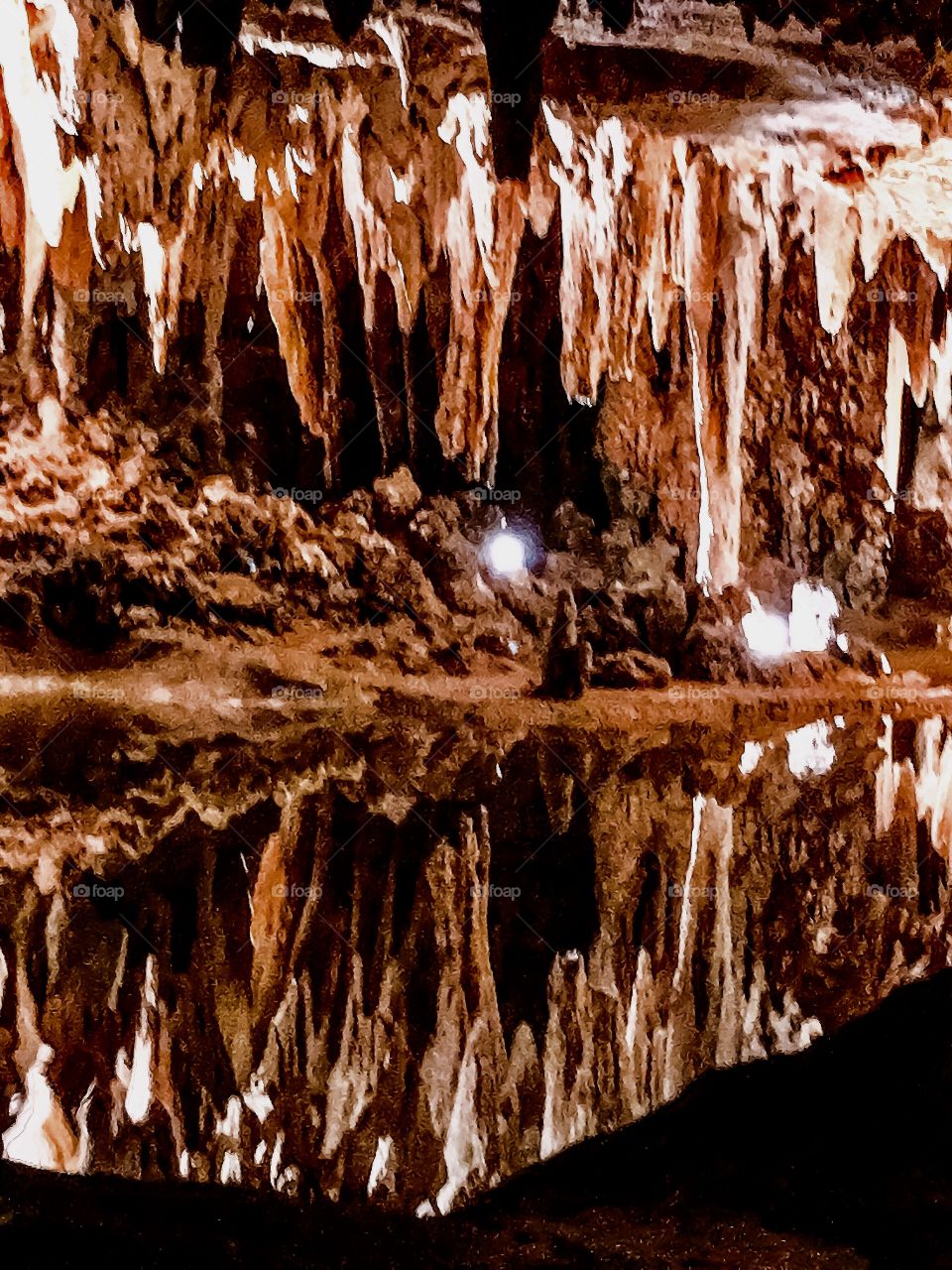 Luray cavern, USA
Beautiful reelection of natural columns deposition 
It's a beautifully designed and decorated by Mother Nature over period of many millions years. Natural deposition of speleothems such as columns, mud flows, stalactites, stalagmites, flowstone are beautifully mirrored on water surface.