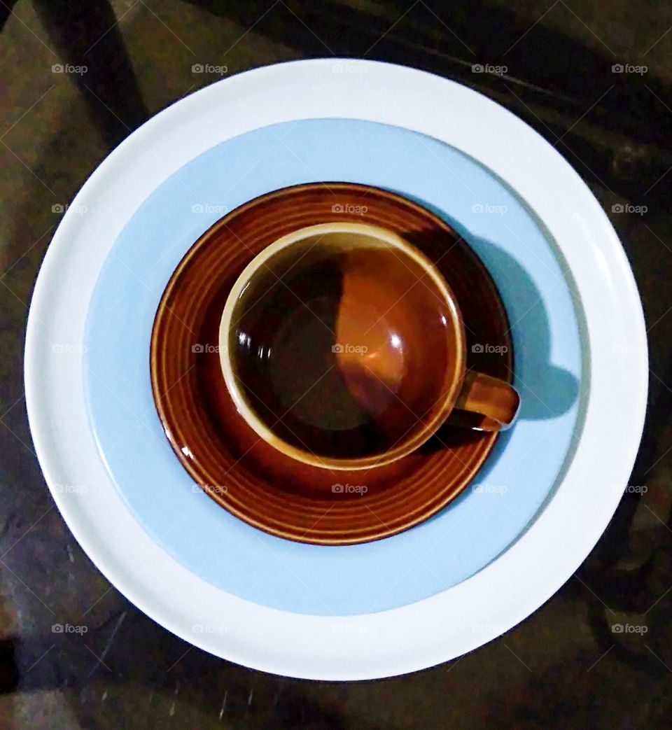 Circle plates with saucer and cup photography.