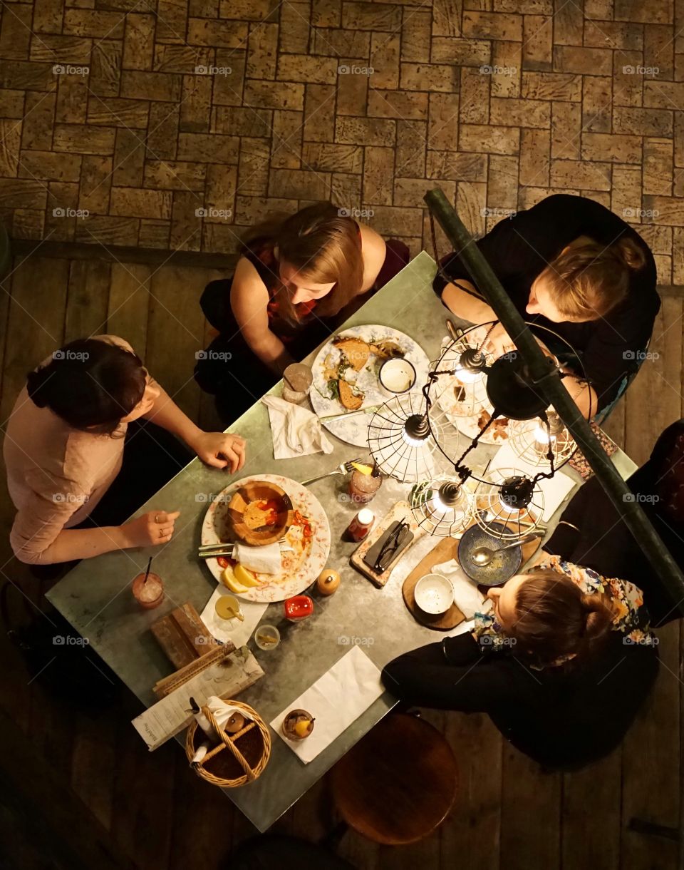 Overhead shot of a group of friends enjoying afternoon lunch 