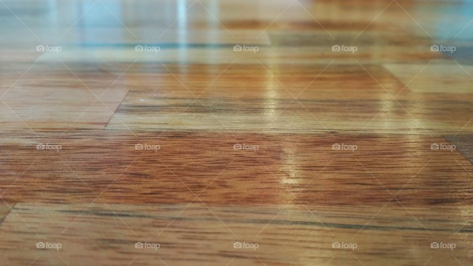 It looks like a wooden floor, or even a wooden-textured wall. But it is actually a table surface in a restaurant.
