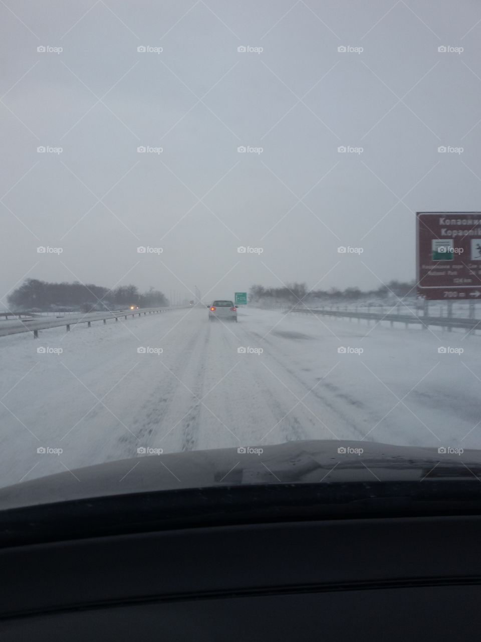 highway covered with snow. view from the car