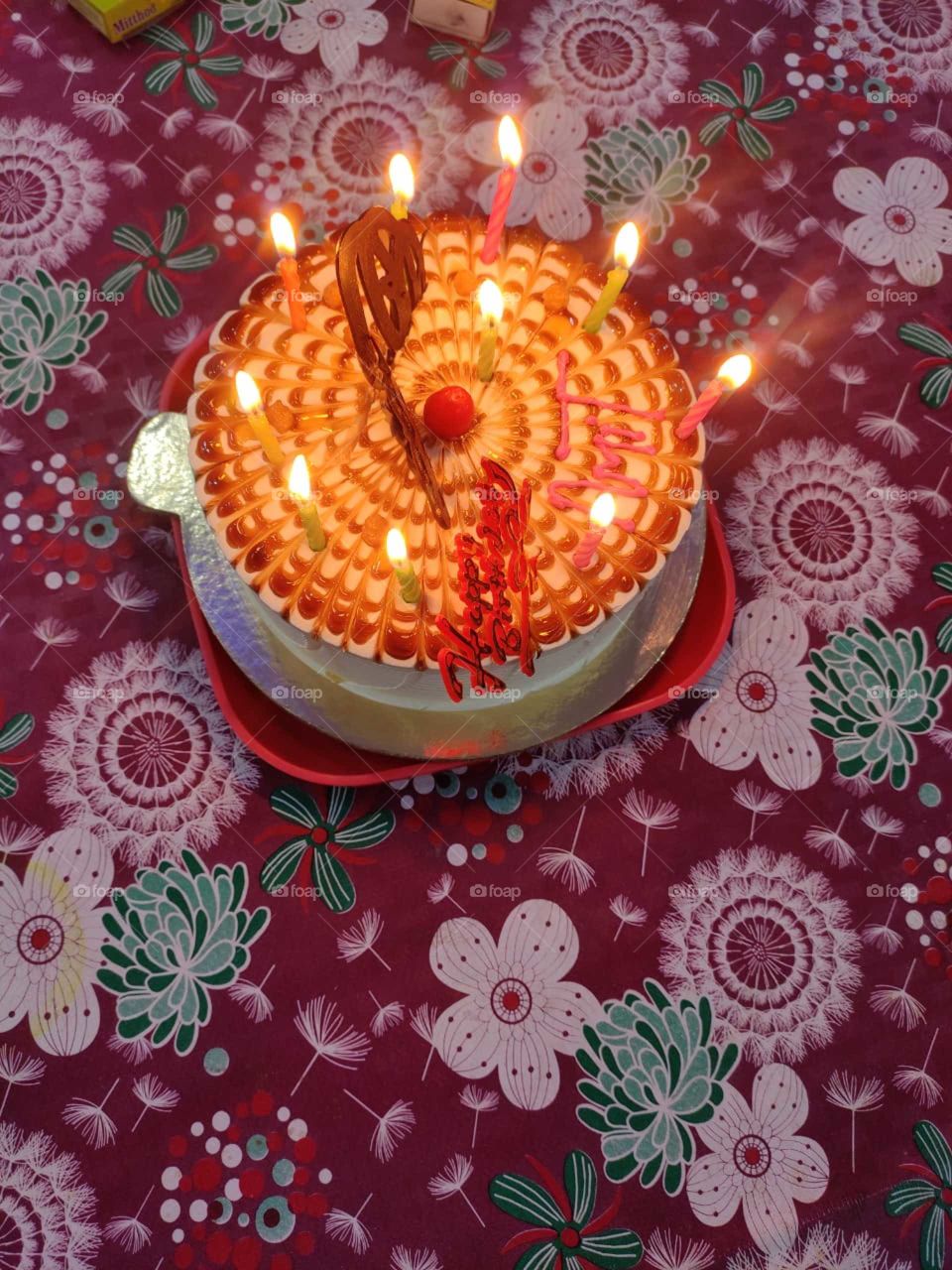 A birthday cake is a cake eaten as part of a birthday celebration. Birthday cakes are often layer cakes with frosting served with small lit candles on top representing the celebrant's age.