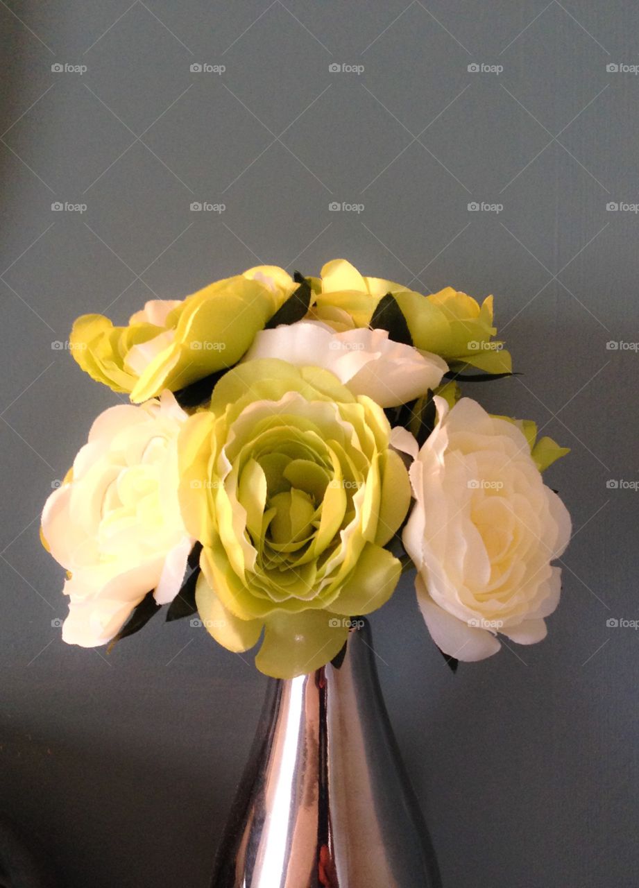 Flowers in vase against grey background