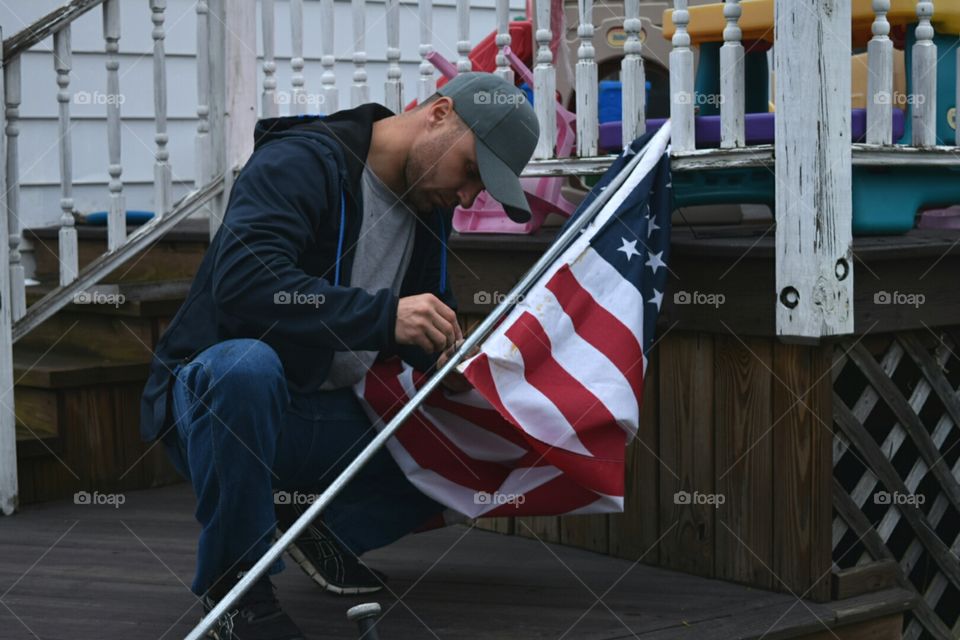 man putting up American flag