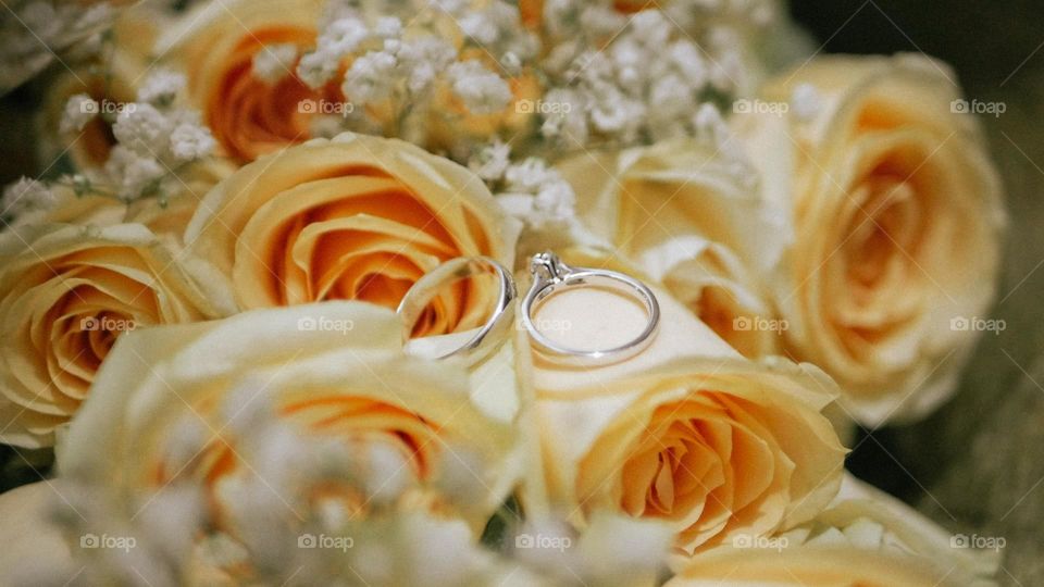 wedding ring in the middle of a rose.