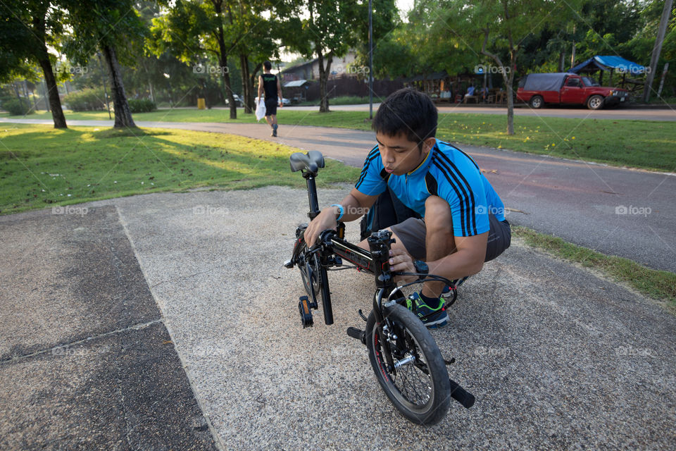 Man fixing bike in the park