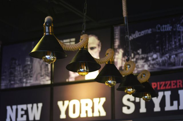 The cafe's stylized lighting consists of hanging martini lamps. graffiti on the walls of New York.