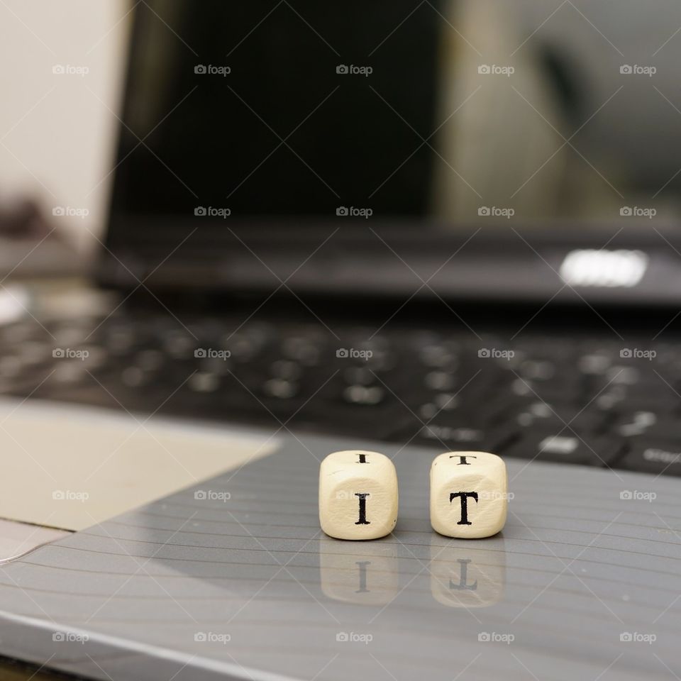 Close-up of dices with laptop