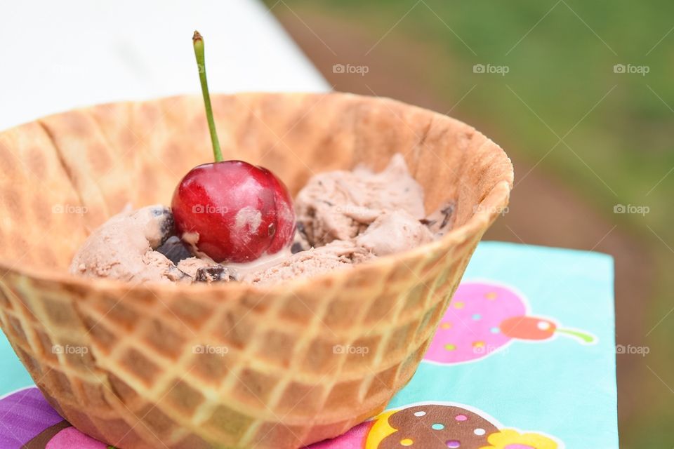 Chocolate ice cream with red cherry