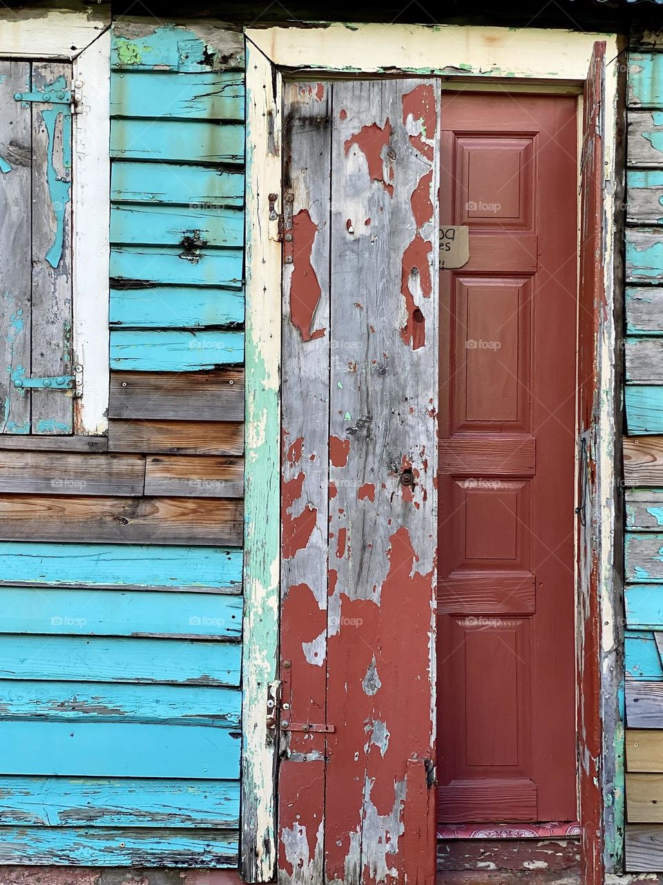 Bright peeling paint on an old wood house