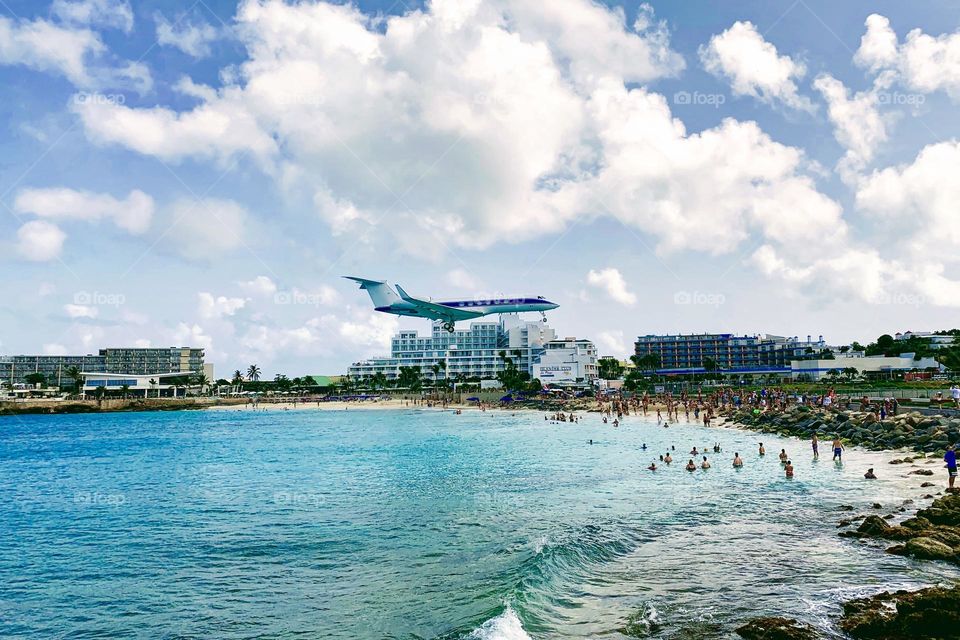 Airplane flying low over the beach