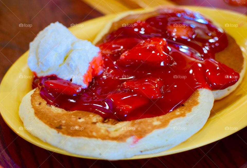 Fresh Pancakes with whipped cream and strawberries 