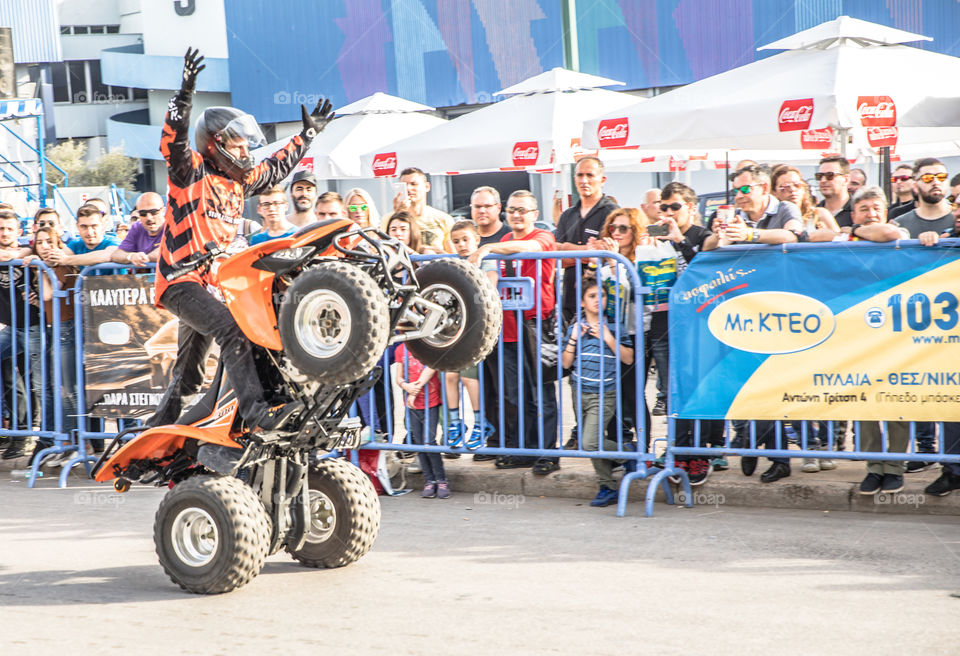 Doing Acrobatics With Quad Bike Terrain Vehicle In Front Of Crowd
