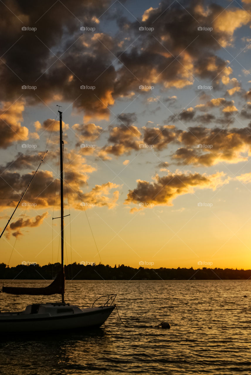Sailboat in harbor while sunsets in upstate New York