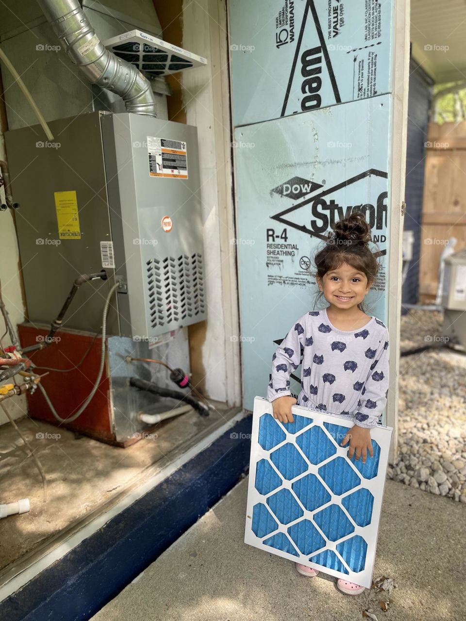 Toddler girl helps mother change furnace filter, home maintenance for your furnace, changing filters with toddlers 