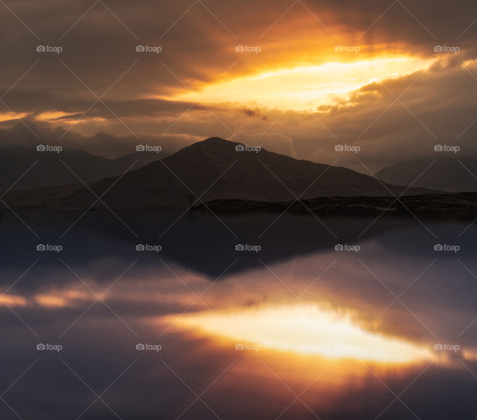 Dramatic cloudy sunrise at Derryclare lake in Athry, County Galway, Ireland