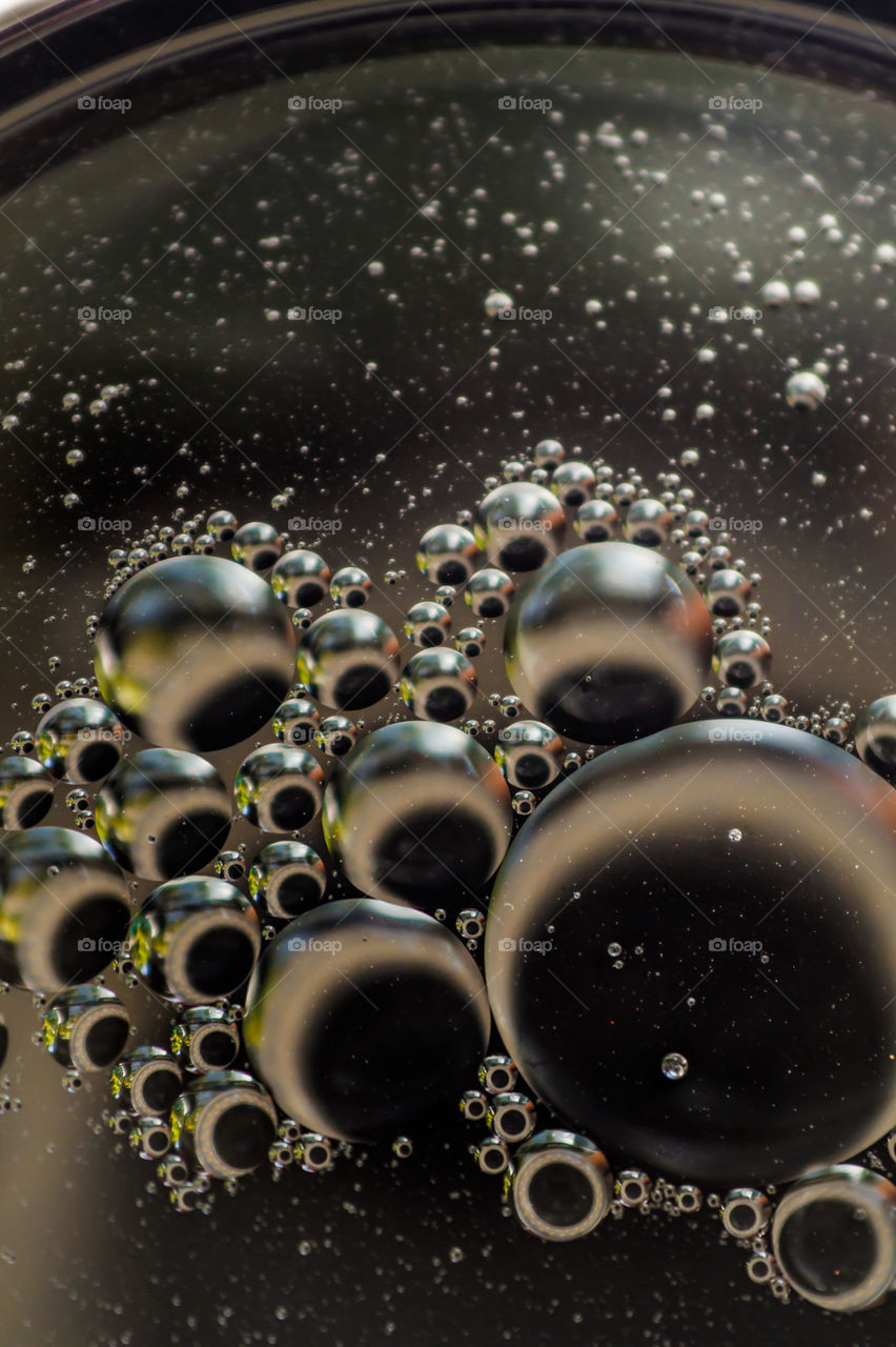 Small bubbles of vegetable oil in water close-up.
