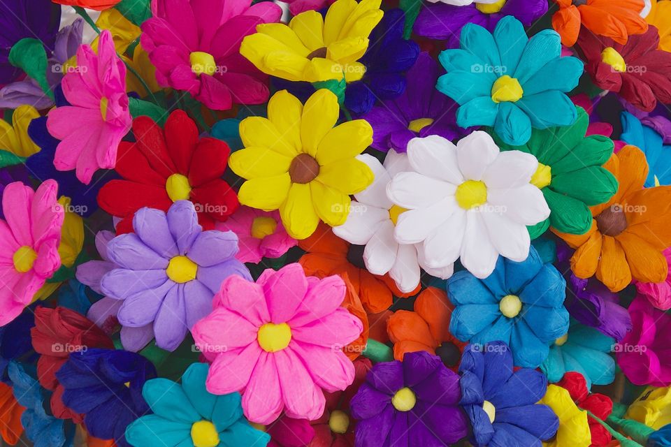 A closeup of a multi colored bouquet of artificial flowers for sale on the street in San Miguel de Allende Mexico.